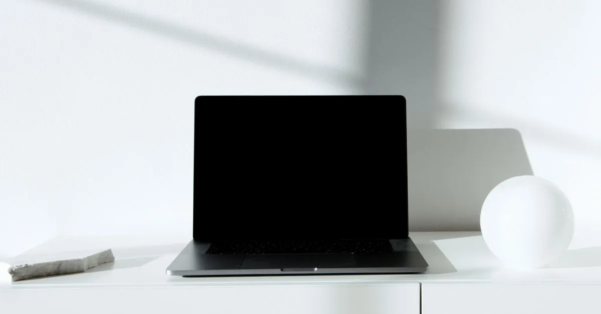 A laptop on a clean, minimal desk, a simple small-business website setup.
